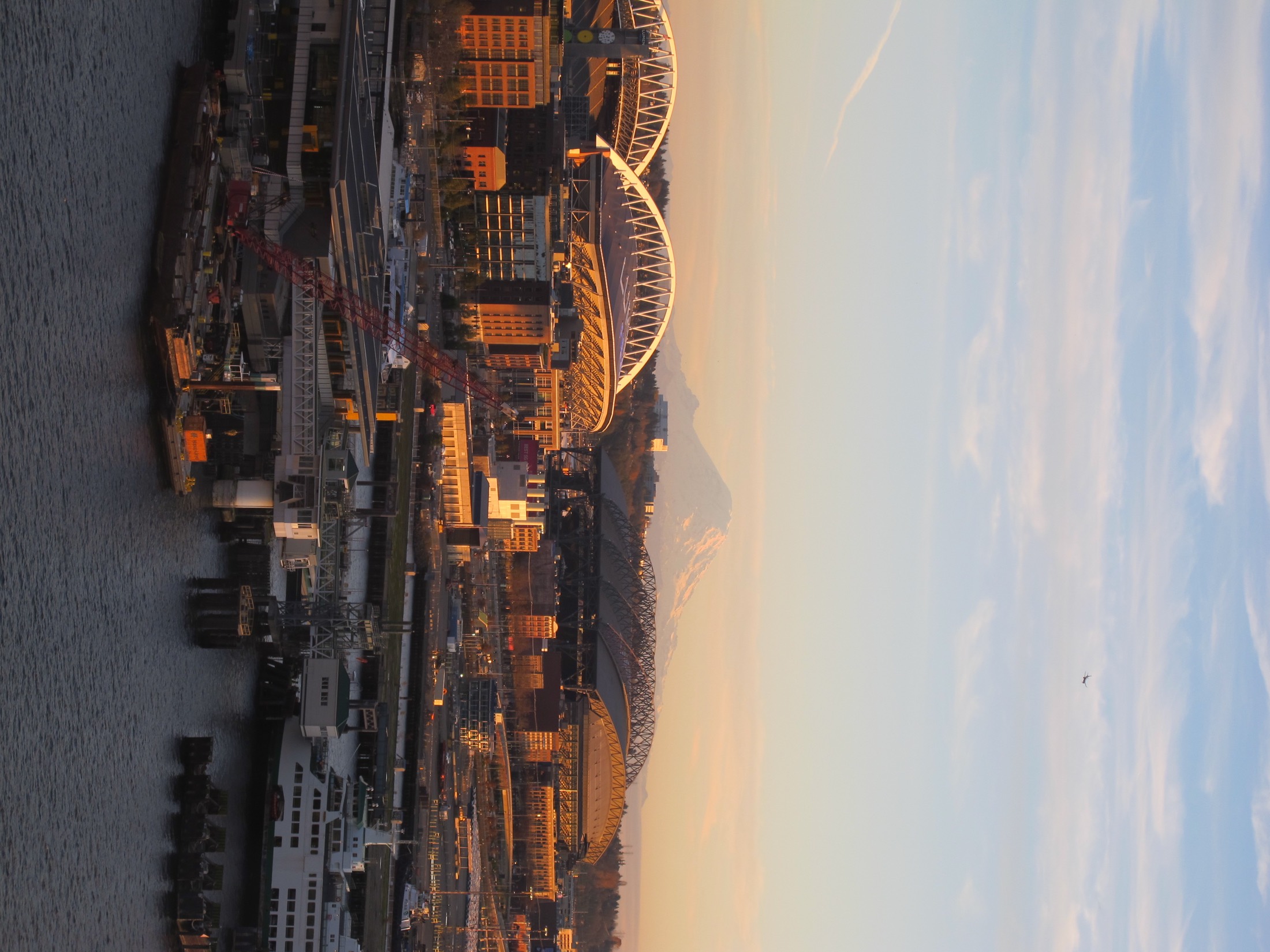Mount Rainier beyond Lumen Field and T-Mobile Park in late afternoon light.