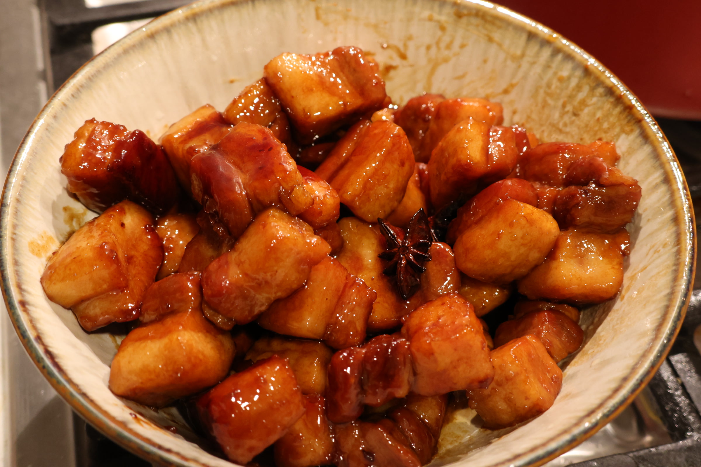 A bowl of homemade red-braised pork with star anise